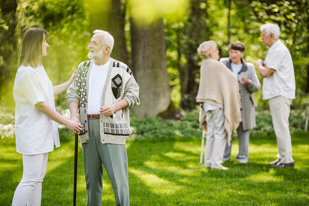 seniors outside an assisted living facility - senior health solutions