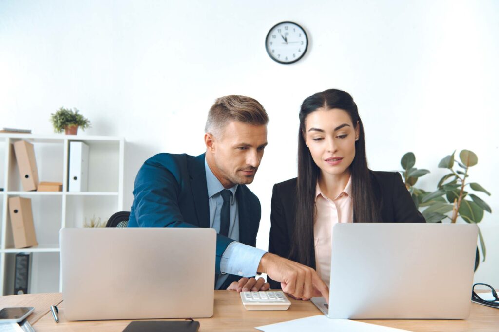 Man and woman at a desk collaborating on a project for a long term care facility in massachusetts